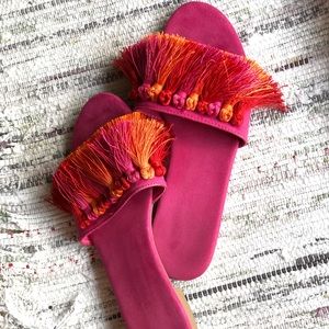 Suede flats in showy pink with equally show stealing orange and pink tassles.